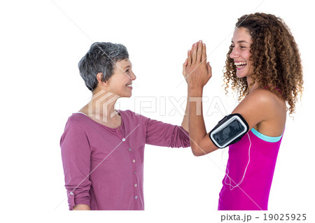 Cheerful women high fiving Cheerful women high fiving 19025925