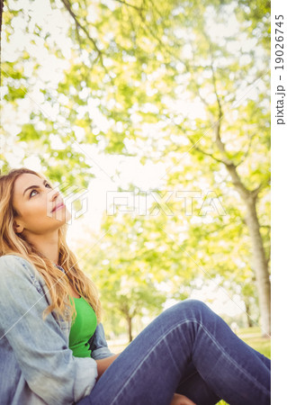 Smiling woman looking up at park 19026745