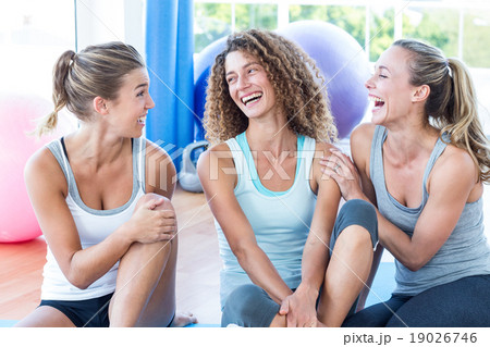Fit women looking at each other and smiling Fit women looking at each other and smiling 19026746