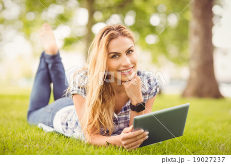 Portrait of smiling woman with hand on chin and holding digital Portrait of smiling woman with hand on chin and holding digital 19027237