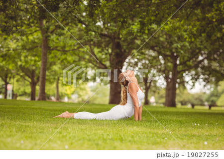 Side view of woman with eyes closed while stretching her body 19027255