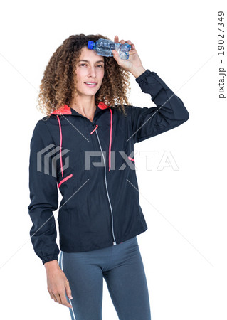 Thoughtful young woman holding water bottle 19027349