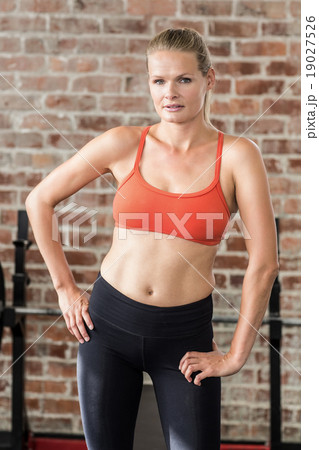 Portrait of serious fit woman looking at camera 19027526