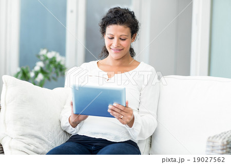 Happy woman using tablet computer Happy woman using tablet computer 19027562