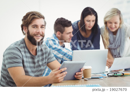 Smiling man holding digital tablet Smiling man holding digital tablet 19027670