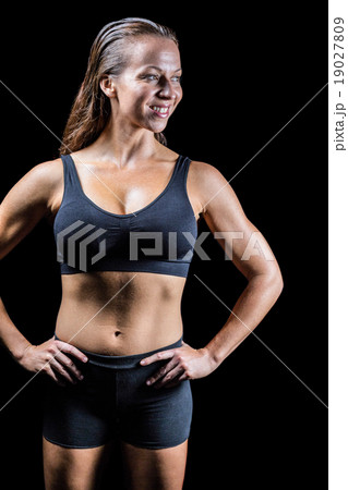 Cheerful athlete with hands on hip Cheerful athlete with hands on hip 19027809