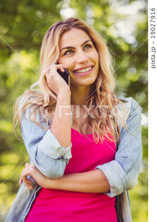 Happy woman talking on mobile phone Happy woman talking on mobile phone 19027916