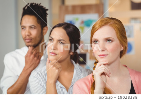Thoughtful business people looking away at office Thoughtful business people looking away at office 19028338