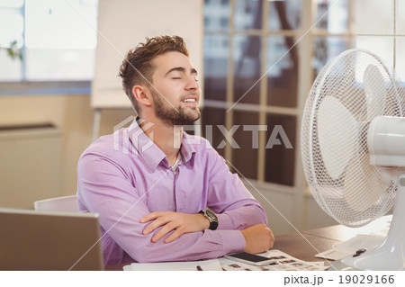 Businessman relaxing in office Businessman relaxing in office 19029166