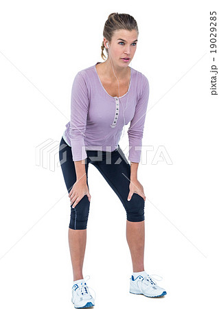 Young woman bending with hand on knee 19029285
