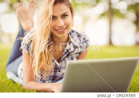 Portrait of happy woman using laptop 19029360