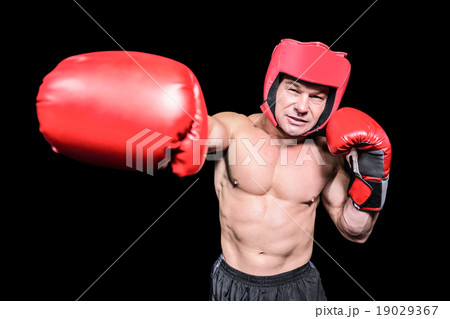 Boxer punching against black background Boxer punching against black background 19029367