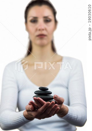 Portrait of woman holding pebbles 19030610
