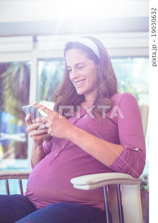 Happy woman text messaging on cellphone Happy woman text messaging on cellphone 19030632