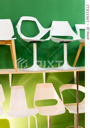 Bar chairs at a modern green backround Bar chairs at a modern green backround 19035812