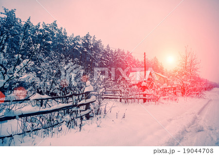 Sunrise over snowy village Sunrise over snowy village 19044708