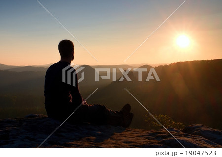 Tourist take a rest on rock and enjoying view  19047523