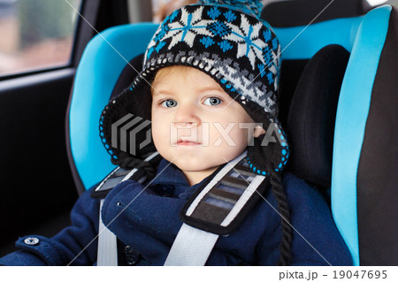 Adorable toddler boy sitting in safety car seat Adorable toddler boy sitting in safety car seat 19047695