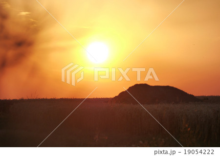 Silhouette of a hill at sundown Silhouette of a hill at sundown 19054222