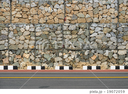Asphalt road with rock wall 19072059