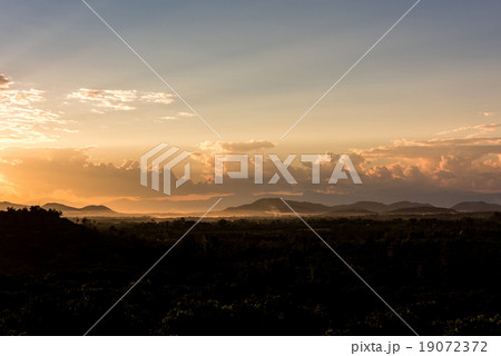 Crepuscular sun rays during sunset over the hill 19072372