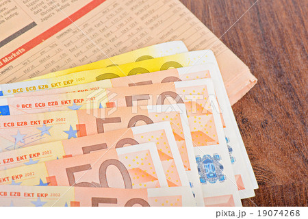 Close-up of Euro banknotes with newspaper Close-up of Euro banknotes with newspaper 19074268