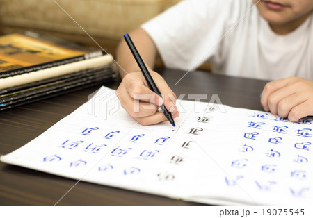 Boy doing work on writing answers an excercise Boy doing work on writing answers an excercise 19075545