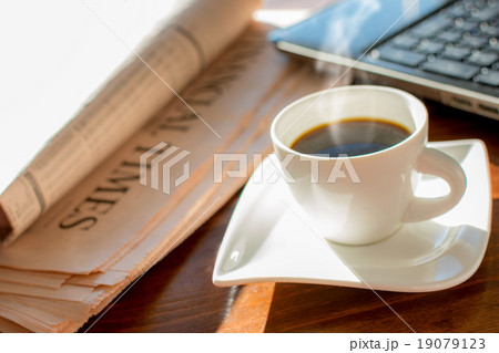 Newspaper with coffee Newspaper with coffee 19079123
