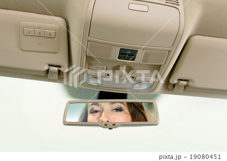 woman looks on the rear-view mirror woman looks on the rear-view mirror 19080451