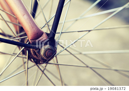 Close up of bicycle wheels in vintage retro style. 19081372