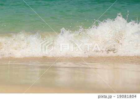 Wave washing up onto sand beach. Wave washing up onto sand beach. 19081804