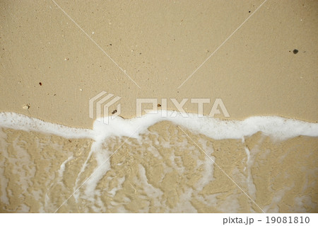 Wave washing up onto sand beach. 19081810