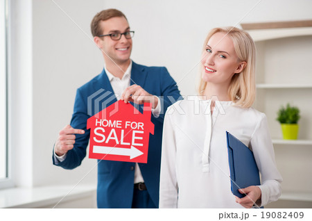Cheerful estate agent is proposing to buy an Cheerful estate agent is proposing to buy an 19082409