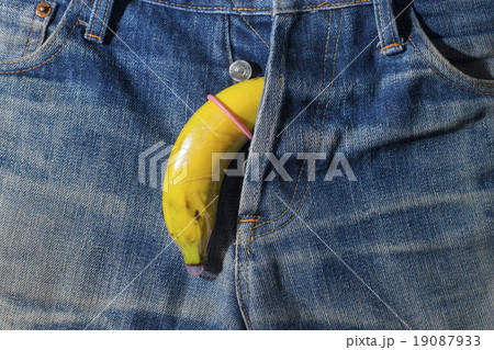 Banana condom on the jeans background 19087933