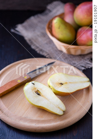 Juicy pears on a rustic wooden kitchen table 19101907