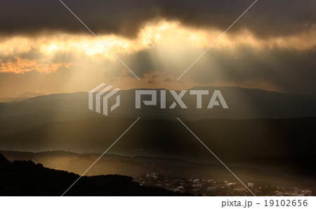 Sunset over the mountain trees 19102656