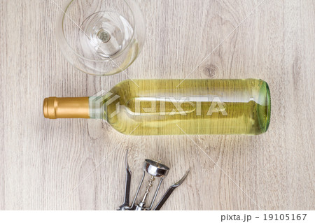 Wine bottle with corkscrew on wooden background 19105167