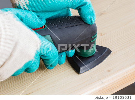 Worker using electric grinder machine 19105631