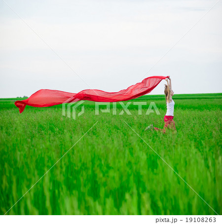 Young lady runing with tissue in green field 19108263