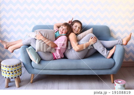 teenager blond sister in pajamas on the sofa teenager blond sister in pajamas on the sofa 19108819