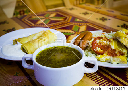 Dish with rice meat soup and sausages on the table Dish with rice meat soup and sausages on the table 19110846