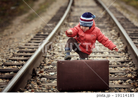 little traveler with a suitcase on the railroad 19114185