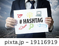 businessman show hashtag text on paper 19116919