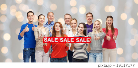 happy people with red sale sign showing thumbs up 19117177