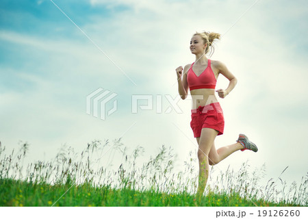 Young woman running summer park rural road. Outdoor exercises. J 19126260