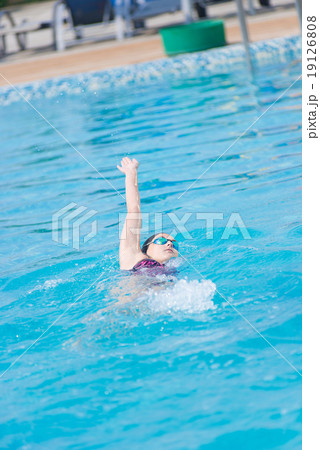 Woman in goggles swimming back crawl style Woman in goggles swimming back crawl style 19126808