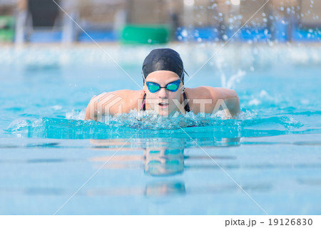 Young girl swimming butterfly stroke style Young girl swimming butterfly stroke style 19126830