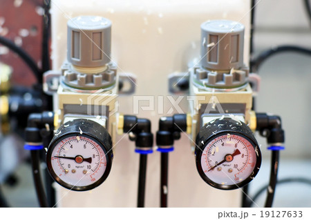 Dial meter on industrial equipment which measures  19127633