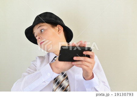 Boy teenager turns away from  cell phone 19130793