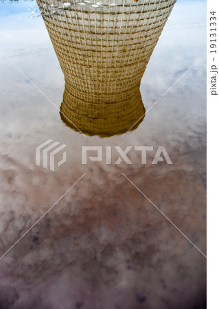 Cooling tower reflected in water 19131334